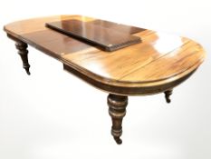 An early 20th century mahogany extending dining table with three leaves,