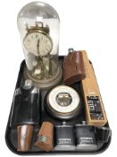 A Hermle brass clock under dome, leather mounted hip flasks and drinking tots, dominoes in box,