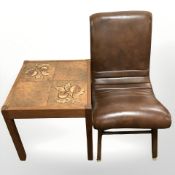 A teak tiled inset lamp table on castors and a brown vinyl chair