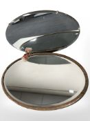 An oak oval mirror and an Art Deco un-framed mirror,