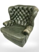 A 20th century Chesterfield style olive leather wingback armchair,