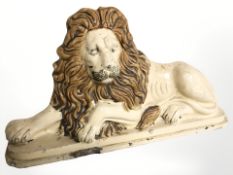 A Victorian Staffordshire glazed earthenware lion doorstop, width 57 cm.