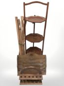 A Japanned three tier folding cake stand, a pipe rack,