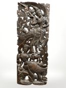 A carved wooden Indonesian panel,