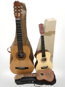 A Spanish acoustic guitar, a Blue Moon four string guitar-ukulele, and a Stagg ukulele.