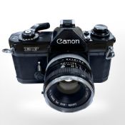 A Canon EF 35mm camera with Canon FD 50mm 1:1.8 lens.