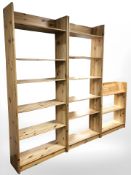 A pair of pine open bookcases and a smaller three tiered bookcase,
