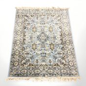 A machine made rug of Persian design, on blue ground,