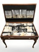 A reproduction mahogany cutlery canteen with tooled red leather inset top,