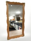 A Danish blonde oak mirror with gilt metal mounts, 95 cm x 50 cm.