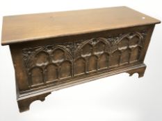 A reproduction carved oak blanket box, 94 cm x 38 cm x 47 cm.