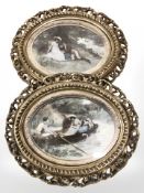 A pair of antiquarian oval overpainted prints in decorative gilt frames,