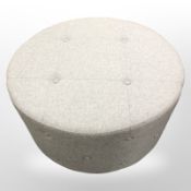 A contemporary grey fabric footstool,