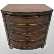 A reproduction miniature four drawer bow fronted chest,