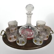 A mahogany brass oval drinks tray containing Atlantis Ships decanter and set of six whisky tumblers