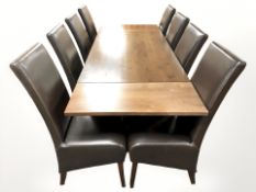 A contemporary extending stained pine rectangular dining table,