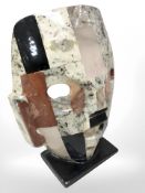 A mosaic work sculpture of a death mask containing semi precious stones,