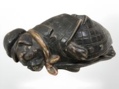 A Bernard Bloch terracotta sculpture of a tipsy dog in checkered rain coat,