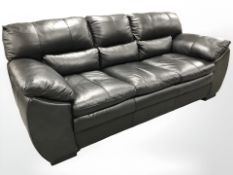 A contemporary black stitched leather three seater settee,