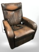 A brown leather electric reclining armchair.