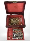 An Oriental brass and hardstone mounted jewellery casket containing assorted gold plated necklaces,