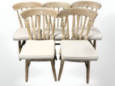 A set of five modern pine farmhouse style dining chairs.
