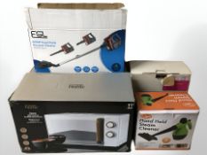 A handheld vacuum cleaner, a microwave, a shredder and a handheld steam cleaner, all boxed.