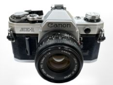 A Canon AE-1 35mm camera with Canon FD 50mm 1:1.8 lens.