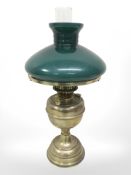 A brass Duplex oil lamp with green glass shade,