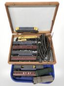 A quantity of Triang rolling stock, track and a glazed counter top display box.