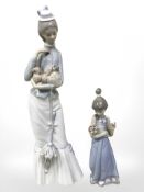 A Lladro figure of a lady with parasol holding a Pekingese and a girl holding flowers,