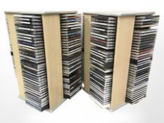 Two revolving CD towers containing assorted CDs including Bob Dylan, Stevie Ray Vaughan, Neil Young,