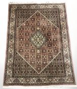 A Tabriz rug, 222 cm x 141 cm.