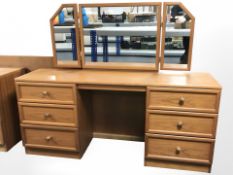 A G Plan teak six drawer mirrorback dressing table and a stool, 154 cm x 49 cm x 124 cm.