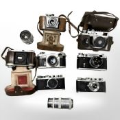 A collection of 35mm SLR and rangefinder cameras including Zorki 1 with fixed 1:3.