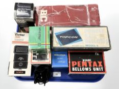 A collection of 35mm camera accessories including Topcon double rail bellows Model-3,