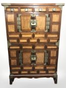 An early 20th century Korean lacquered elm and brass mounted cabinet,
