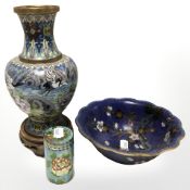 A 20th century Japanese cloisonne vase depicting storks in flight on carved wooden stand,