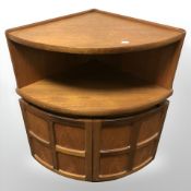 A Nathan teak bow-front corner cabinet,
