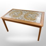 A tiled topped teak coffee table,