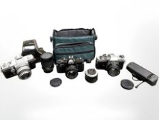 A Canon AV-1 35mm camera with Canon FD 50mm 1:1.8 lens, Topcon RE-2 35mm camera with RE.