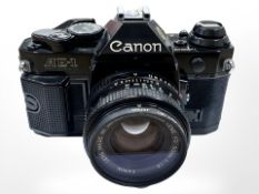 A Canon AE-1 Program 35mm camera with Canon FD 50mm 1:1.8 lens and Hoya 52mm 1B skylight filter.