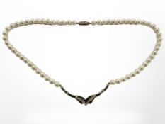 A good quality cultured pearl necklace with 18ct yellow gold square cut sapphire and round