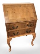 A reproduction yew wood bureau,