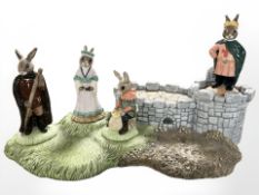 A Royal Doulton Bunnykins Robin Hood Collection stand containing figurines Little John, Maid Marion,