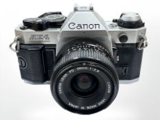A Canon AE-1 Program 35mm camera with Canon FD 28mm 1:2.8 lens.