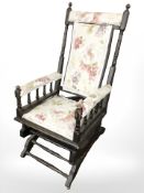 An early 20th century rocking chair in floral upholstery (as found)