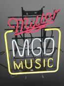 A Miller MGD Music neon sign,