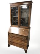 A late Victorian inlaid mahogany bureau bookcase,