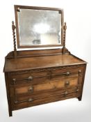 An Edwardian oak three drawer mirror back dressing chest, 110 cm x 47 cm x 137 cm.